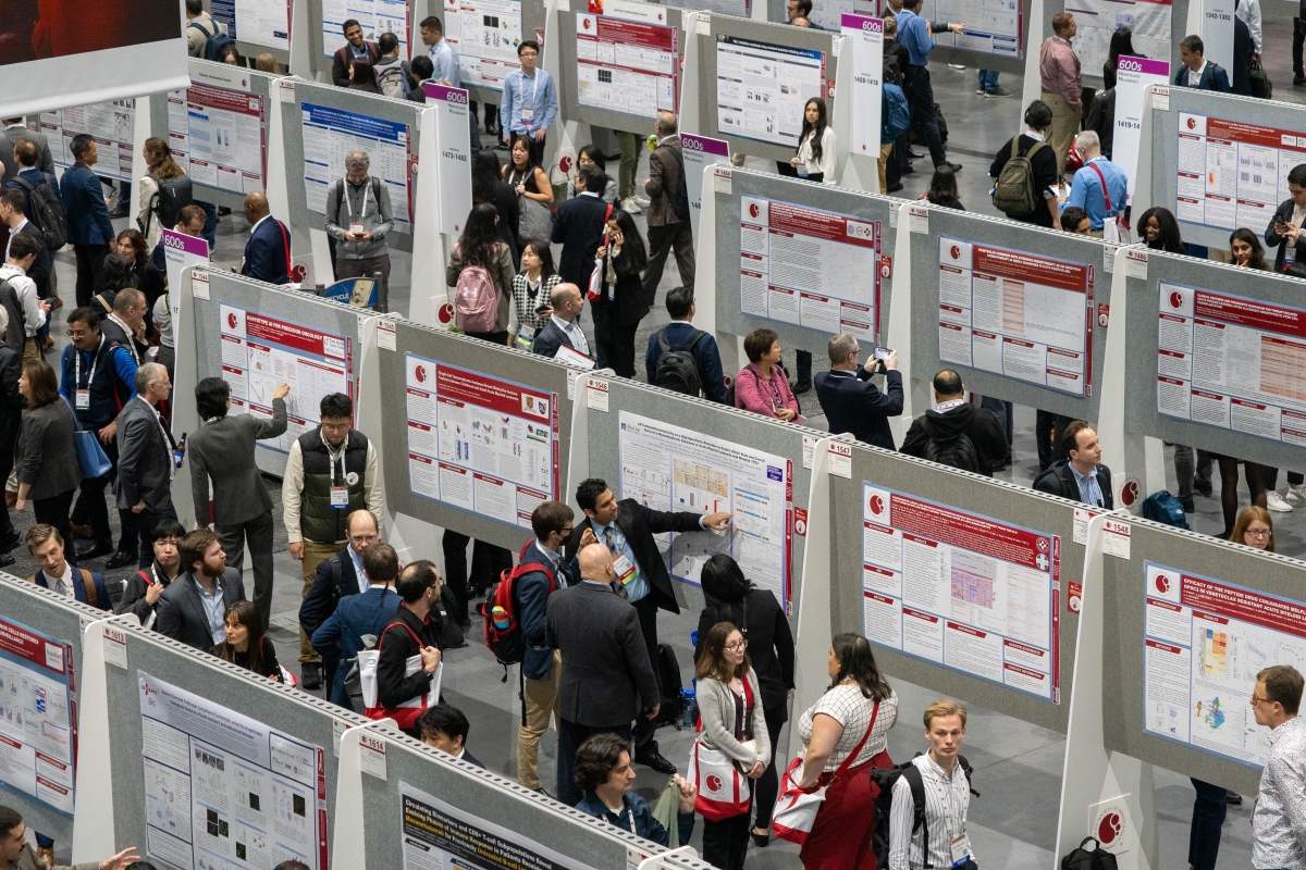 Many attendees and poster presenters interact in the poster hall.