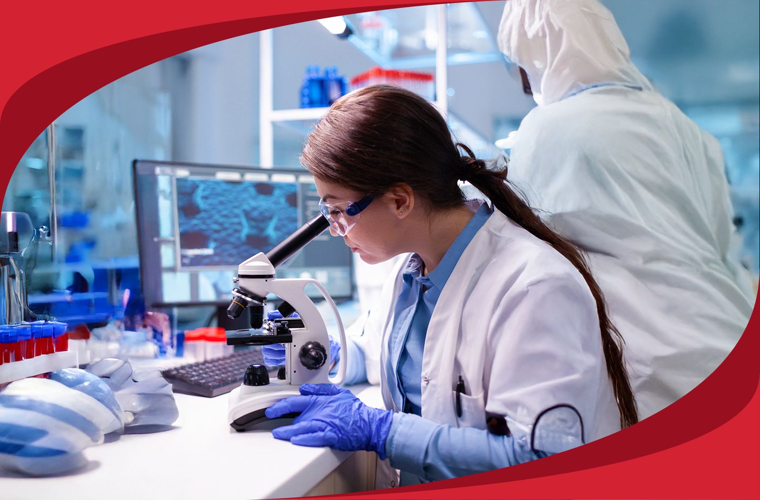 Two medical professionals analyze a sample in a lab environment.