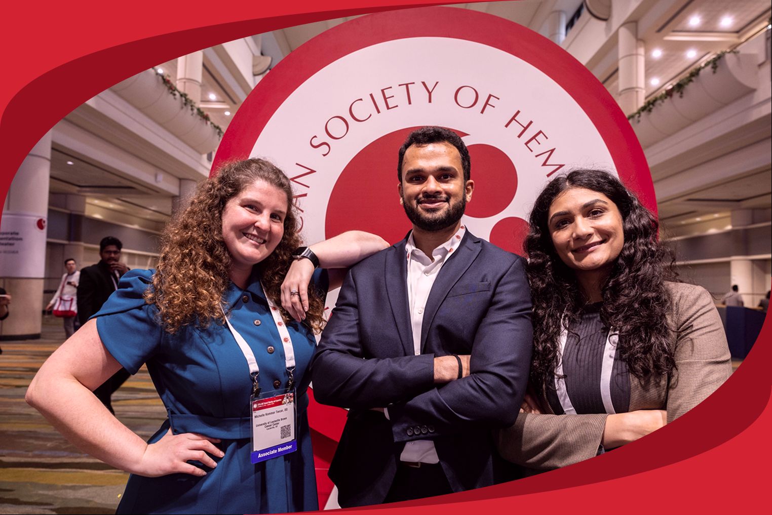 Three people pose in front of the ASH logo at the annual meeting.