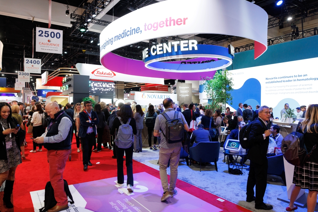 Attendees interact with exhibitors at the annual meeting.