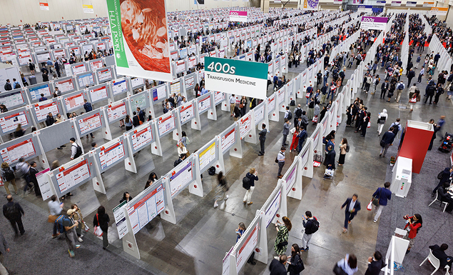 People mingle among thousands of posters in the poster hall