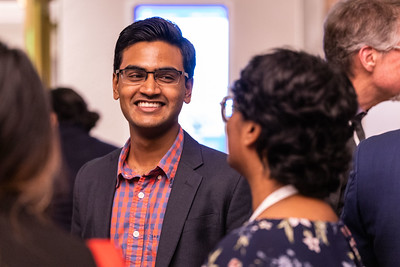 Two ASH meeting attendees talk and smile together.