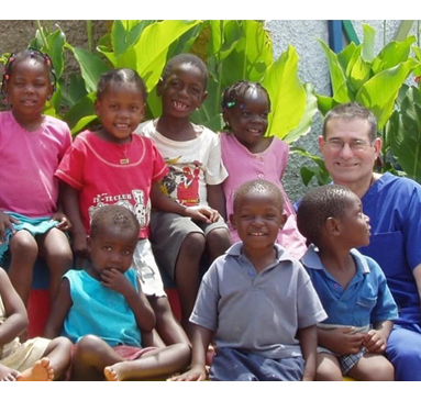 Dr. Stossel with a group of children