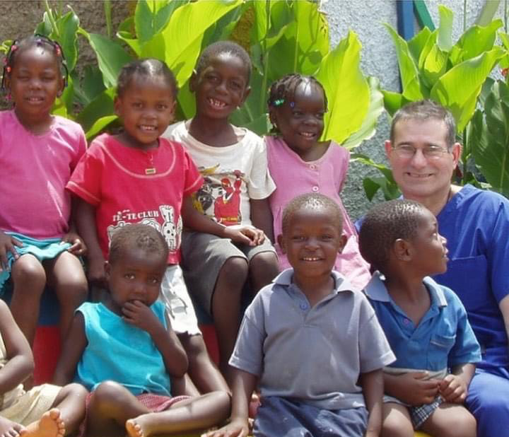Dr. Stossel with a group of children