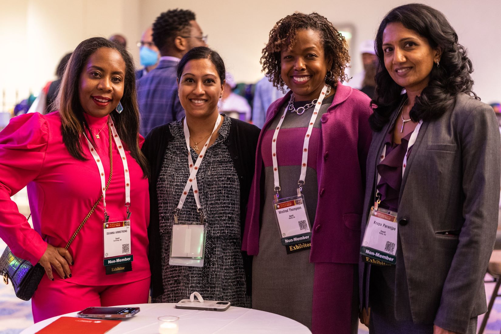 Women pose for a photo at an annual meeting event