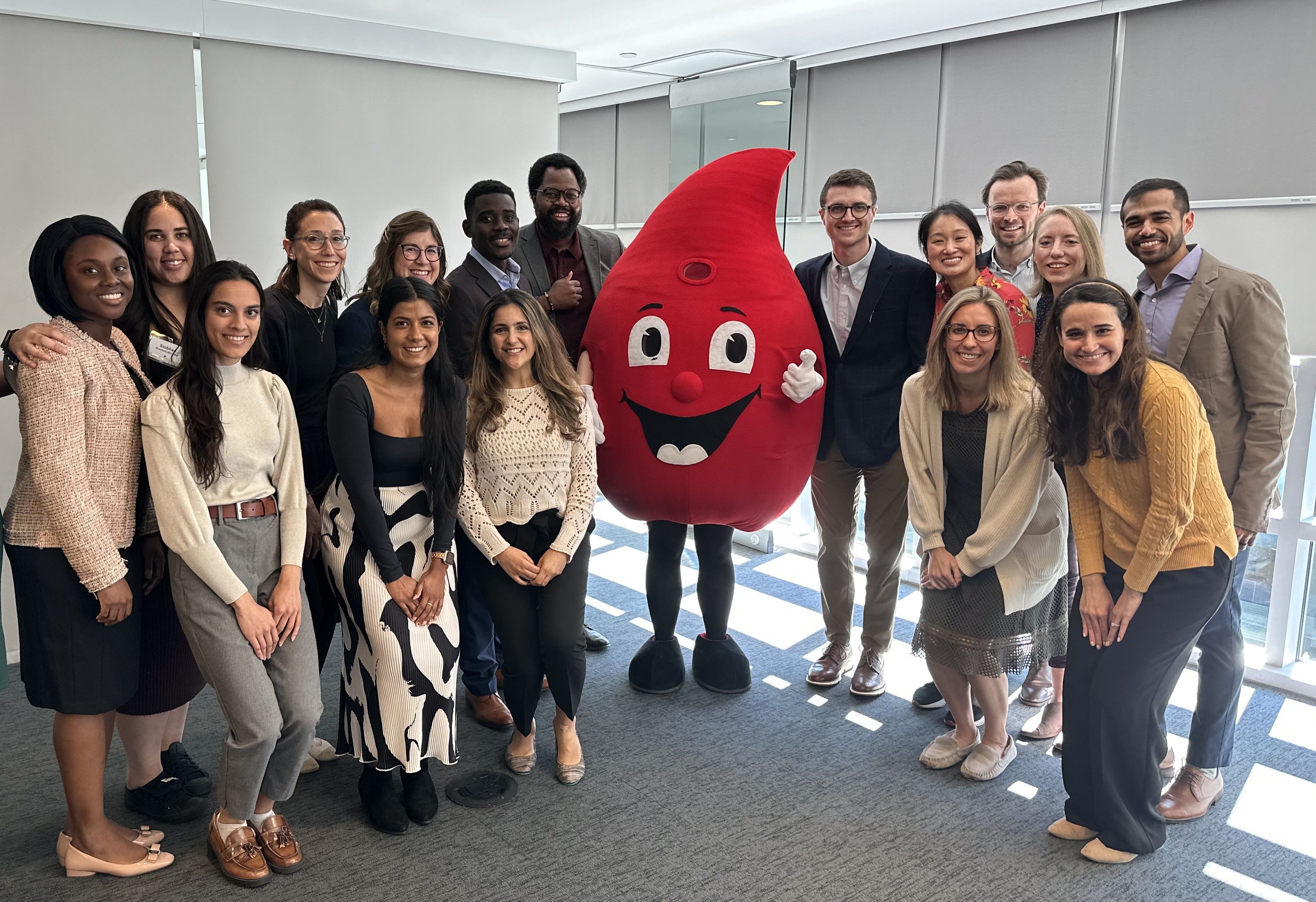 The 2023 Trainee Council poses with ASH's Mascot, Red.