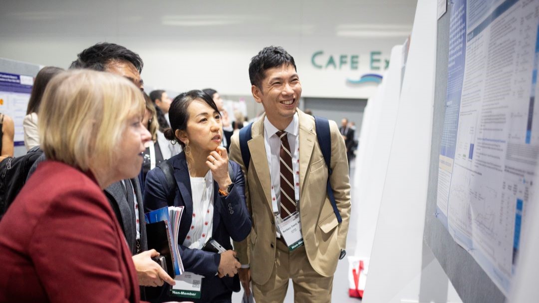 Annual Meeting attendees view and discuss an abstract.